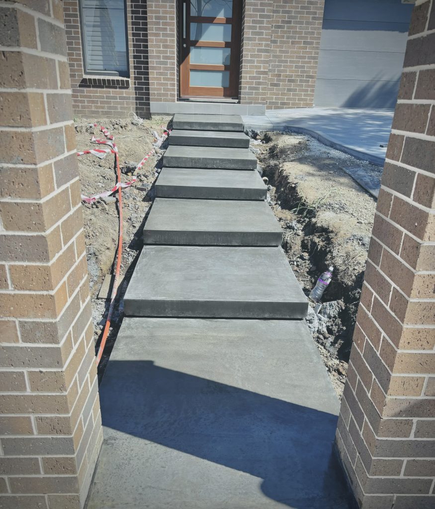 Concrete Floating Stairs in a Voodoo colour with a burnished finish by ocon construction sydney